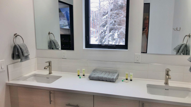 The Second Bathroom is ensuite to the Second Bedroom and has a double sink vanity and a window that opens up to the trees outside.