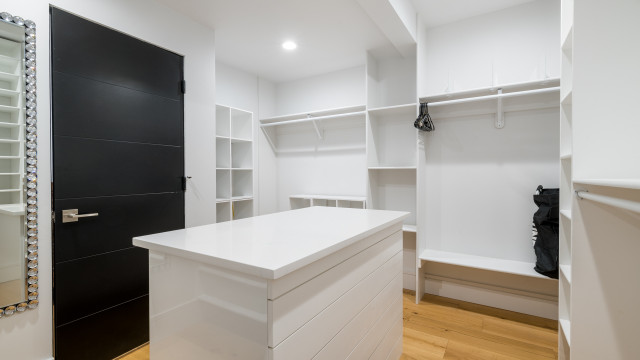 A dream walk in closet with a built in dresser and lots of organized space.A dream walk in closet with a built in dresser and lots of organized space.