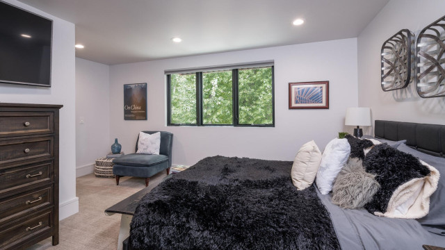 The Second Bedroom is privately located on the West side of the Second Level. It has radiant heat flooring and it's own mini-split AC/Heat wall mounted unit, as well as an ensuite bathroom with a spacious walk in shower and another "smart" TV.