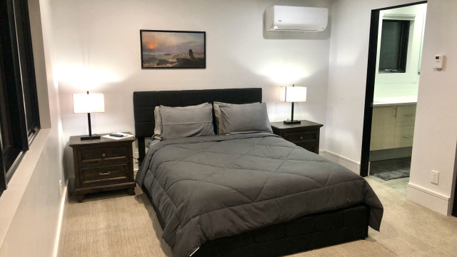 The Second Bedroom is privately located on the West side of the Second Level. It has radiant heat flooring and it's own mini-split AC/Heat wall mounted unit, as well as an ensuite bathroom with a spacious walk in shower and another "smart" TV.